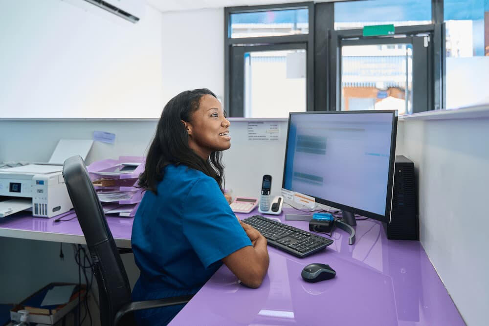 Teenage students using computers in computer room