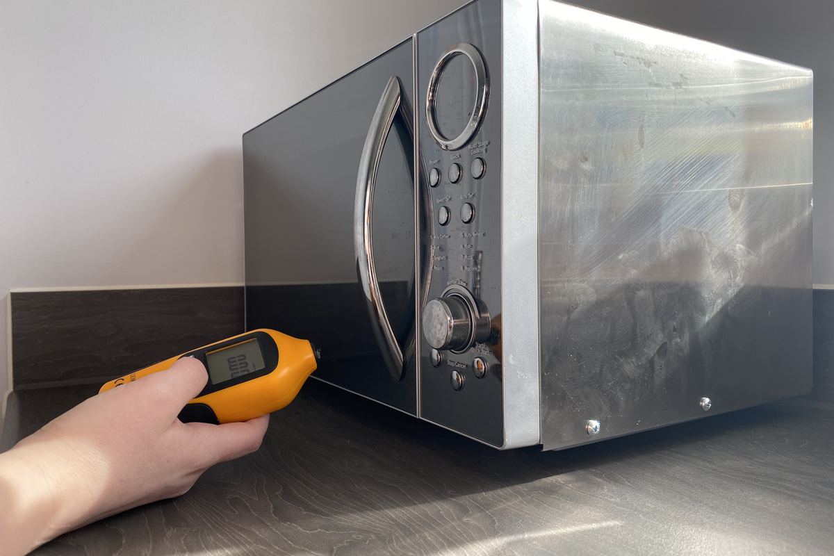 Microwave emissions being measured around the door seal with a leakage meter